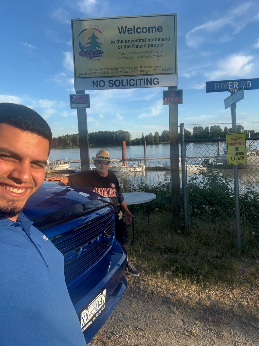 Sina with a customer and a blue Ram by the Fraser River